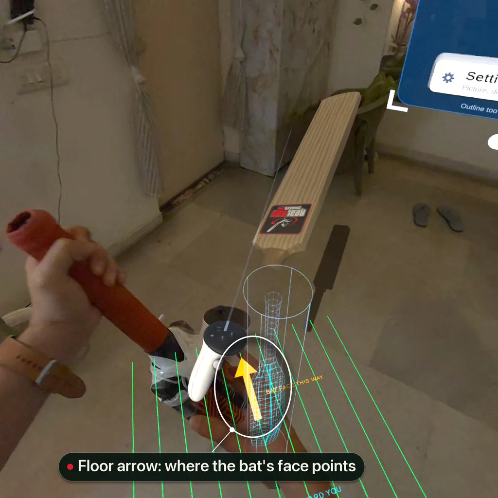 A real bat with a taped controller being brought to the calibration outline; the orange floor arrow showing the way the bat's face points is highlighted